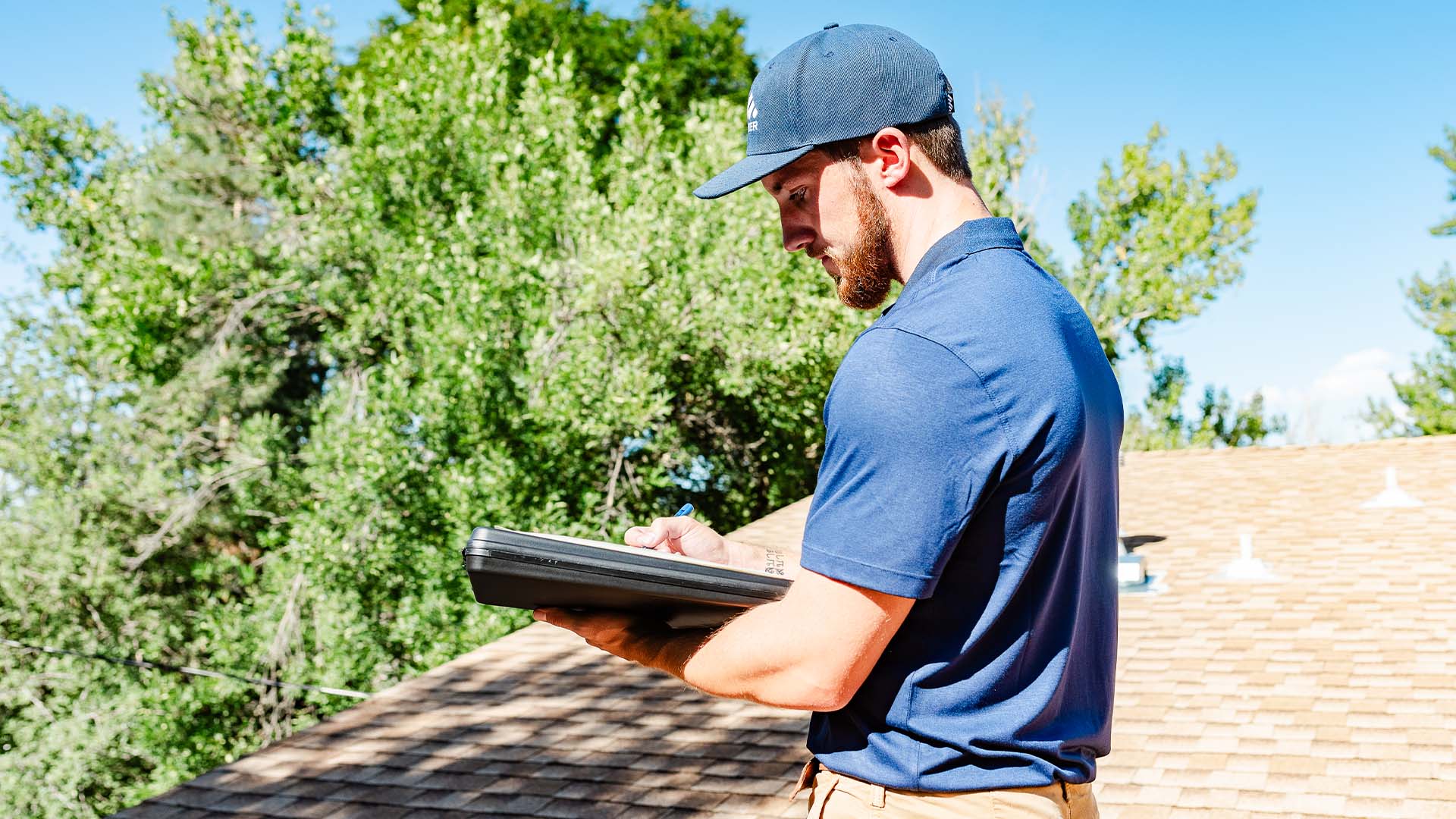 Premier Roofing technician performing a roof inspection